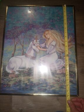 framed artwork is a print titled "Girl and Unicorn" by artist Judy Mastrangelo.